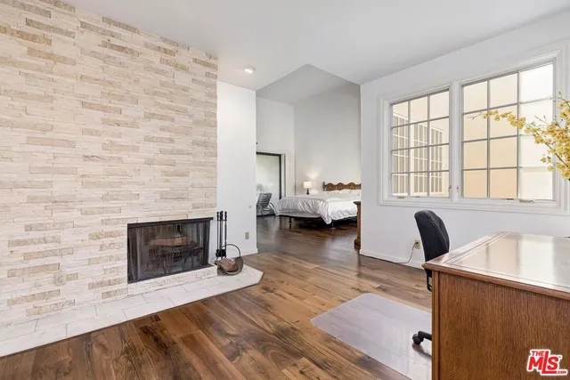 a living room with furniture large window and a fireplace