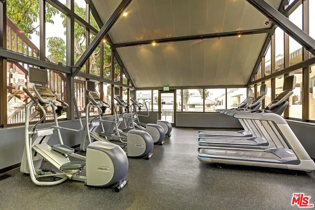a view of gym room with windows and couch