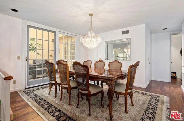 a view of a a dining room with furniture window and wooden floor