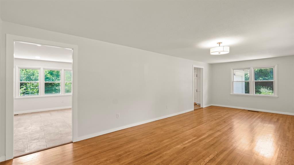 4600 Robinwood Drive Waco, TX 76708 - Photo 2 of 24 a view of an empty room with wooden floor and a window