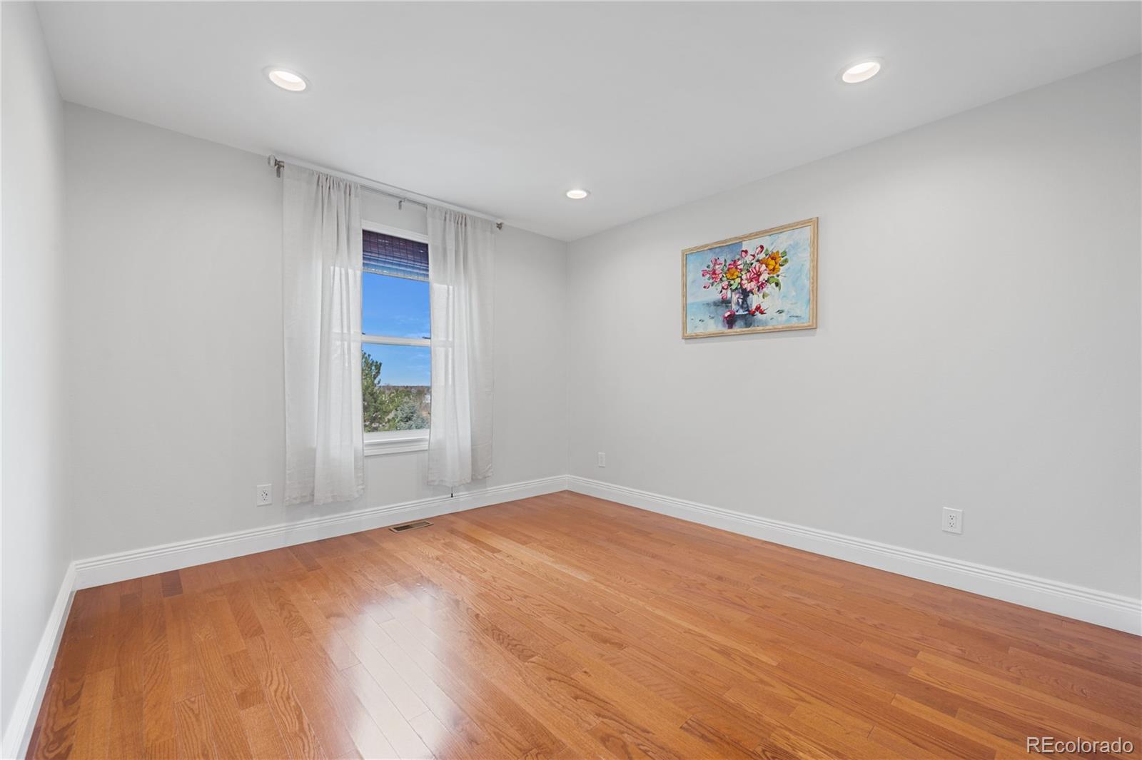 851 Hughes Lane Highlands Ranch, CO 80126 - Photo 25 of 50 a view of empty room with wooden floor and fan