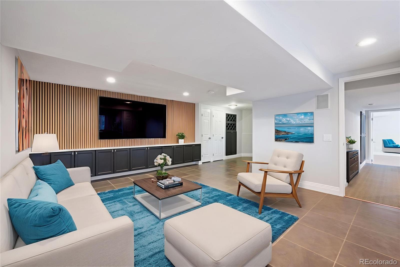 851 Hughes Lane Highlands Ranch, CO 80126 - Photo 30 of 50 a living room with furniture and a flat screen tv