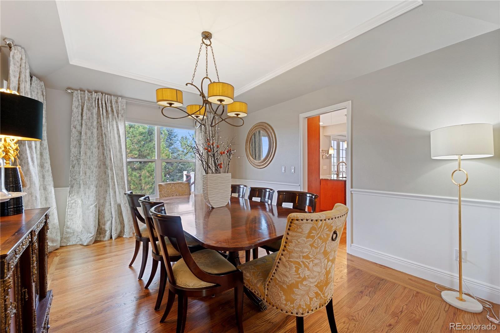 851 Hughes Lane Highlands Ranch, CO 80126 - Photo 5 of 50 a dining room with furniture a chandelier and wooden floor