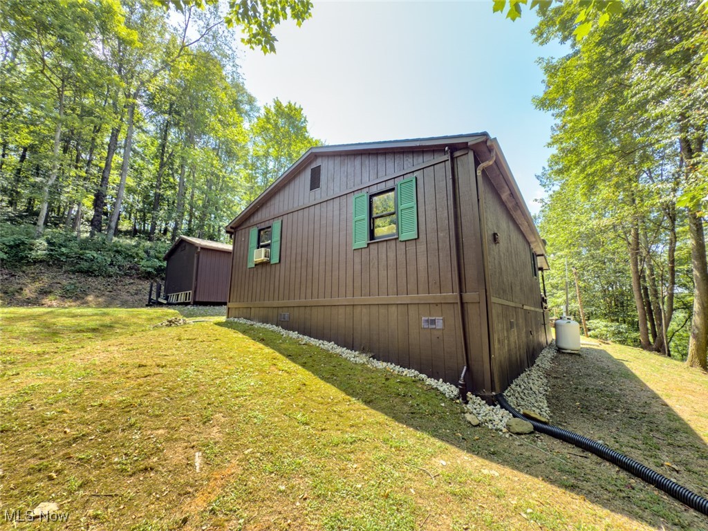34390 Barber Ridge Road Lewisville, OH 43754 - Photo 29 of 50 View of side of property featuring a yard and view of scattered trees