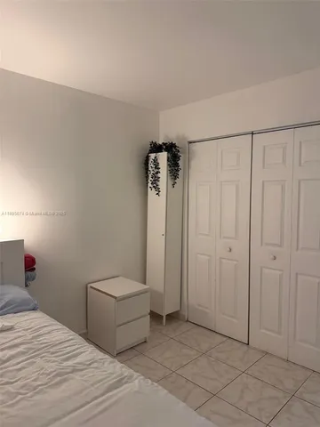 a bedroom with a bed and a shower