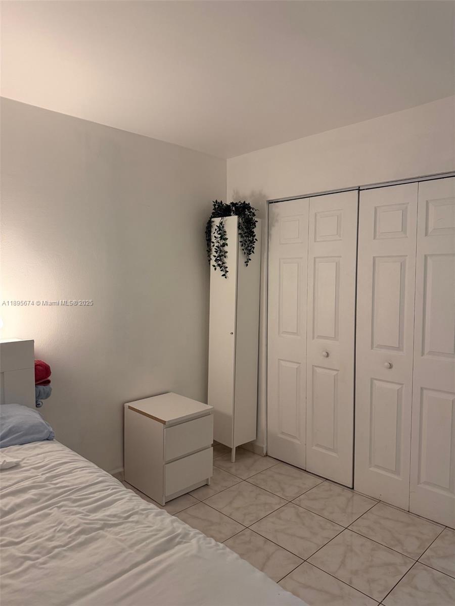 15620 Southwest 80th Street, Unit H205 Miami, FL 33193 - Photo 11 of 12 a bedroom with a bed and a shower