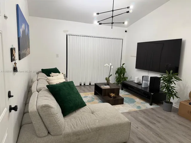 a bedroom with a bed window and a flat screen tv