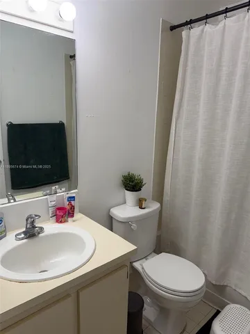 a bathroom with a sink toilet and a mirror