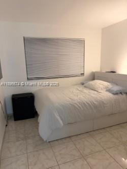 15620 Southwest 80th Street, Unit H205 Miami, FL 33193 - Photo 10 of 12 a bedroom with a bed and a dresser
