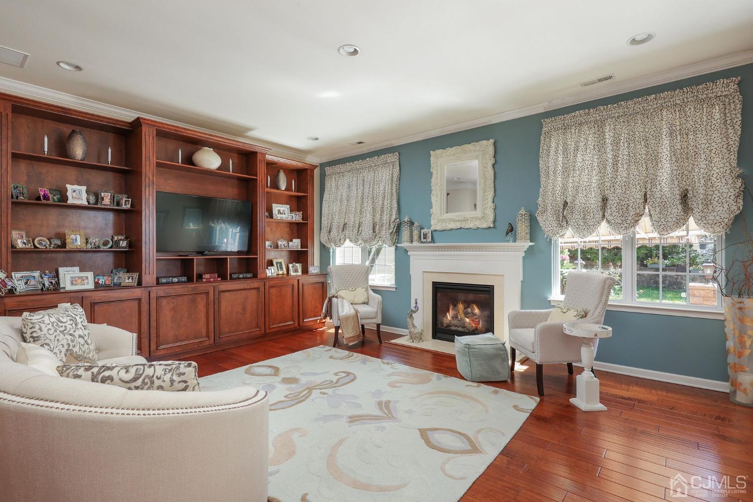 170 Tournament Drive Monroe Township, NJ 08831 - Photo 12 of 36 a living room with furniture a fireplace and a flat screen tv