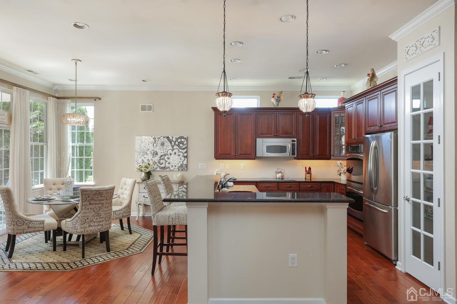 170 Tournament Drive Monroe Township, NJ 08831 - Photo 19 of 36 a kitchen with kitchen island granite countertop a sink and refrigerator