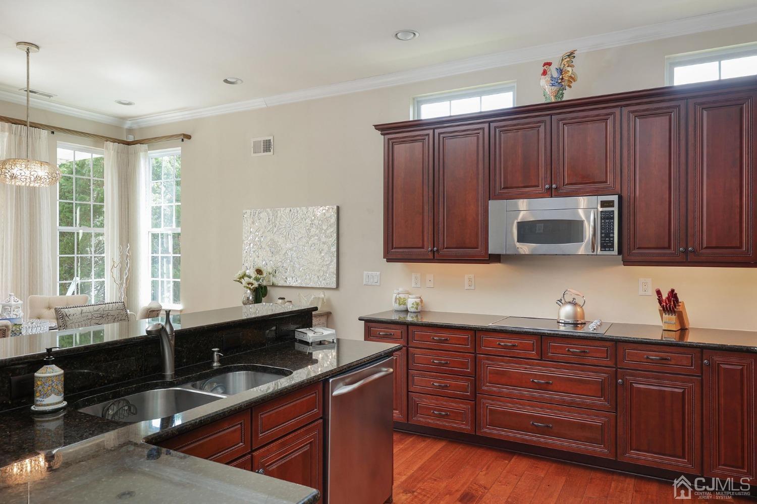 170 Tournament Drive Monroe Township, NJ 08831 - Photo 20 of 36 a kitchen with stainless steel appliances wooden cabinets and a sink