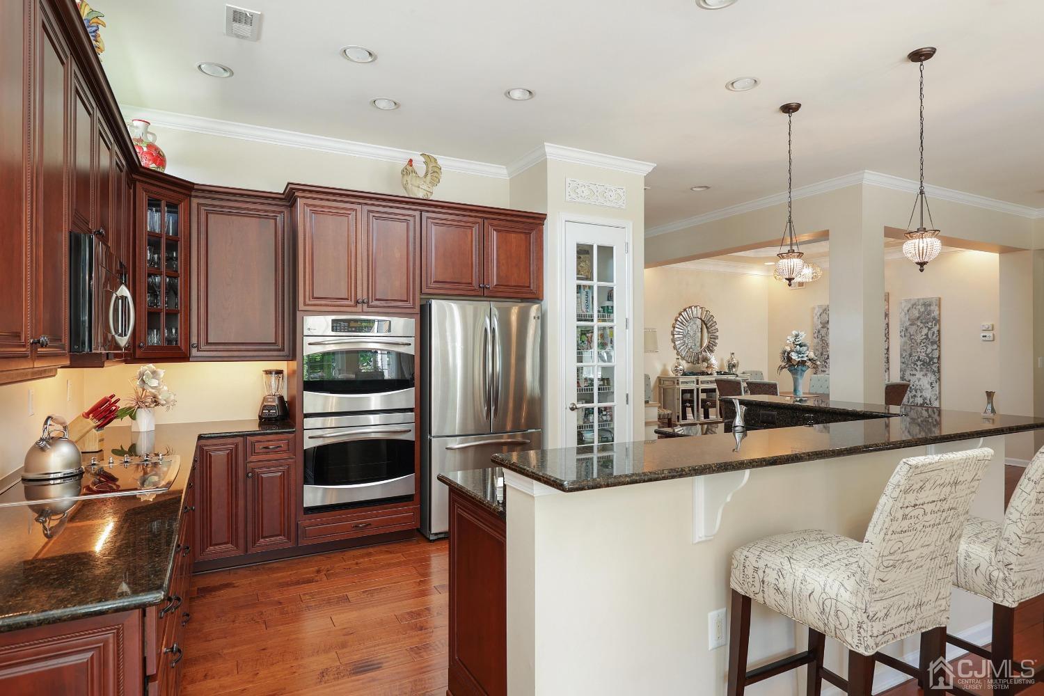 170 Tournament Drive Monroe Township, NJ 08831 - Photo 21 of 36 a kitchen with stainless steel appliances granite countertop a sink refrigerator and cabinets