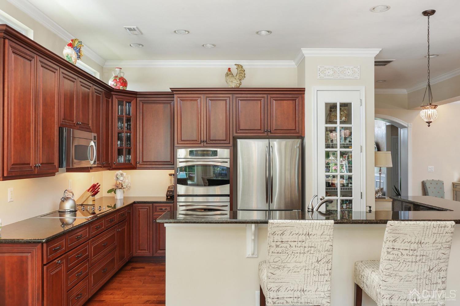 170 Tournament Drive Monroe Township, NJ 08831 - Photo 23 of 36 a kitchen with stainless steel appliances granite countertop a refrigerator and a stove top oven
