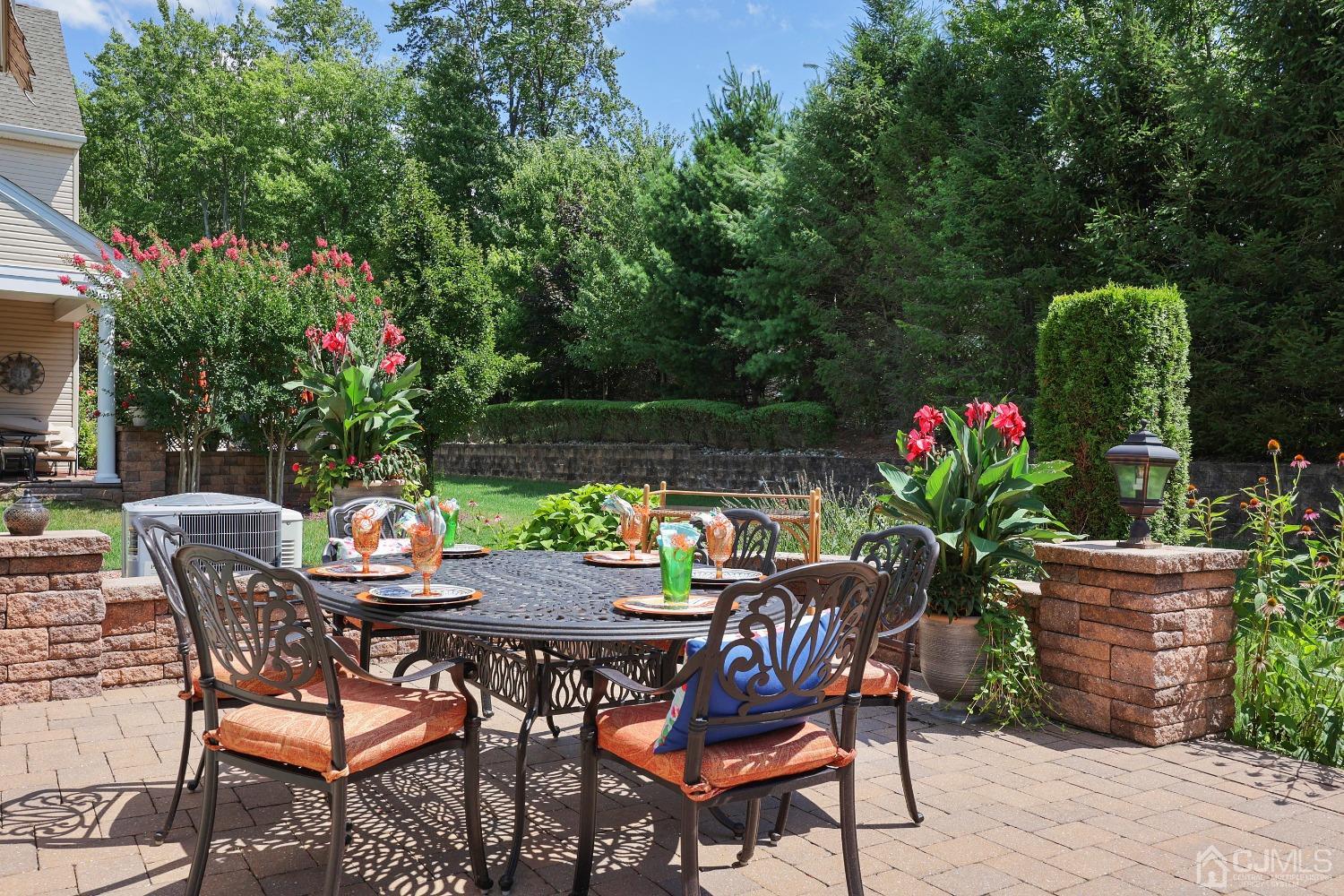 170 Tournament Drive Monroe Township, NJ 08831 - Photo 32 of 36 a patio with couple of chairs and a flower garden