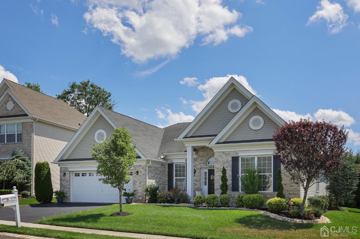 170 Tournament Drive Monroe Township, NJ 08831 - Photo 4 of 36 a front view of a house with garden