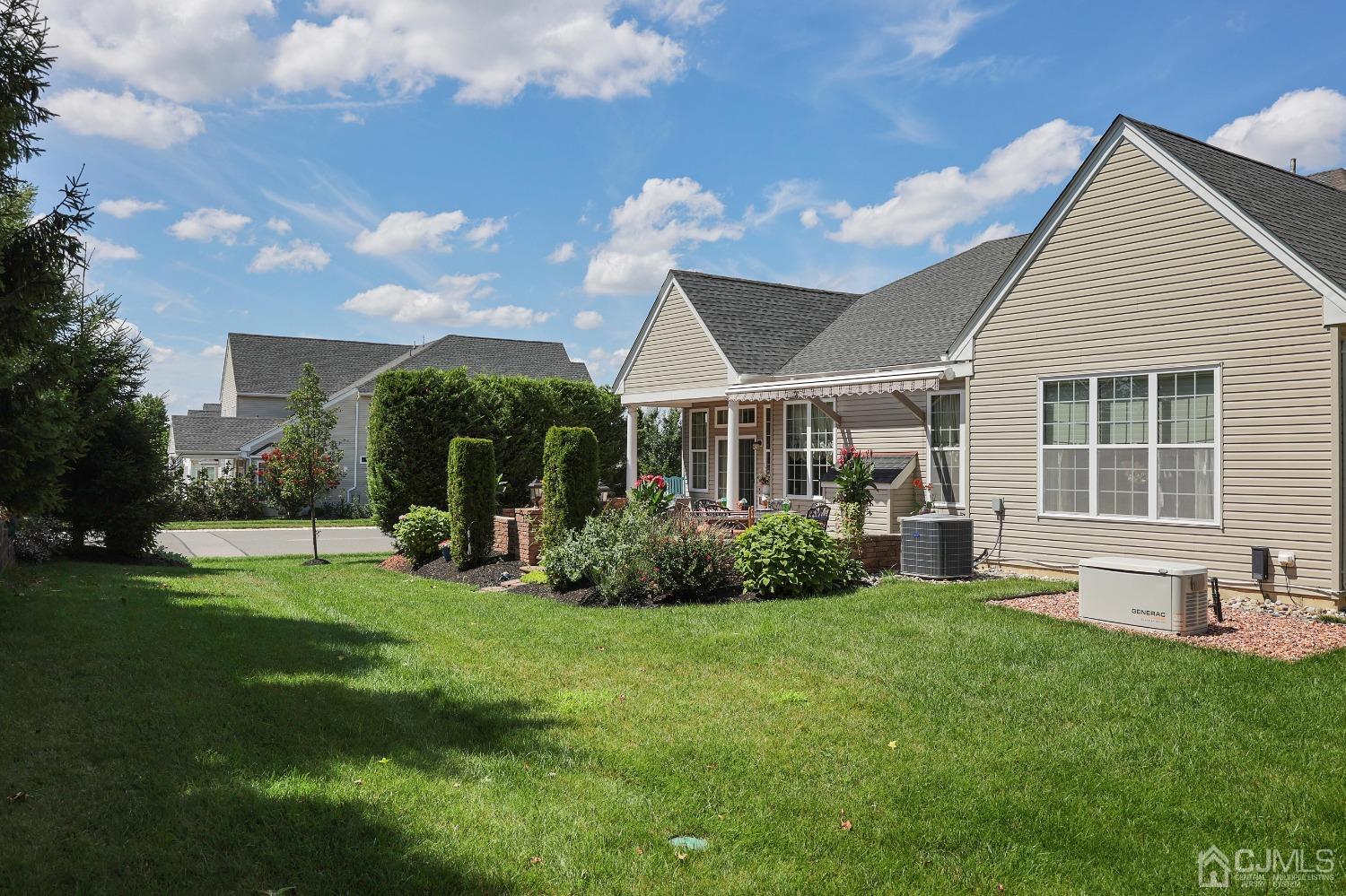 170 Tournament Drive Monroe Township, NJ 08831 - Photo 9 of 36 a view of a house with a yard and sitting area