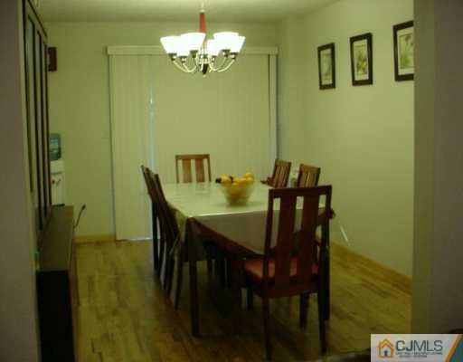 6606 Hana Road Edison, NJ 08817 - Photo 3 of 8 a view of a dining room with furniture and chandelier