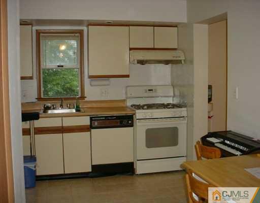 6606 Hana Road Edison, NJ 08817 - Photo 4 of 8 a kitchen with a stove and a sink