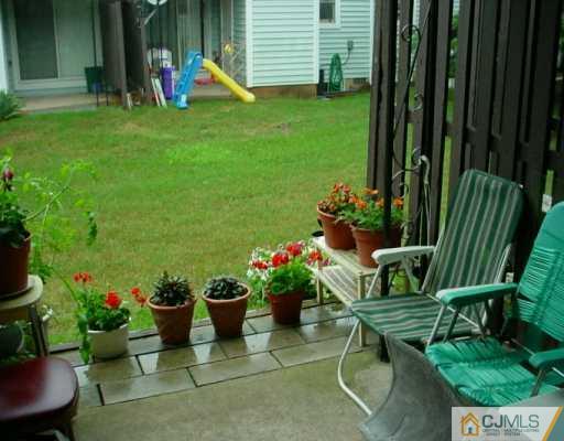 6606 Hana Road Edison, NJ 08817 - Photo 8 of 8 a garden with a table and a chairs