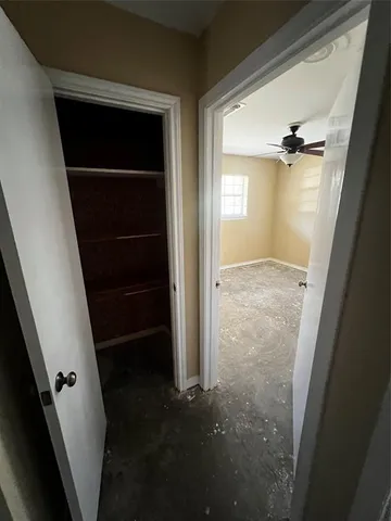 a view of a livingroom with a ceiling fan and window