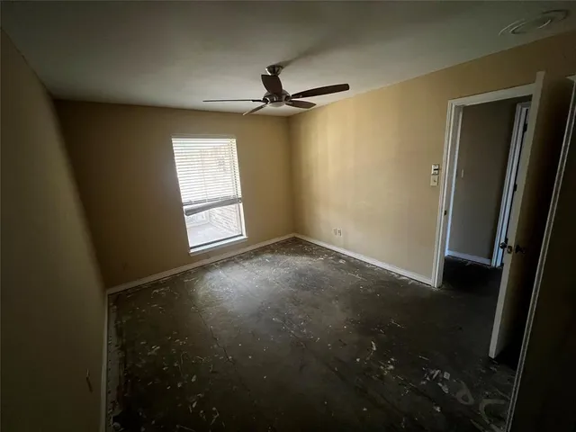 a view of empty room with ceiling fan