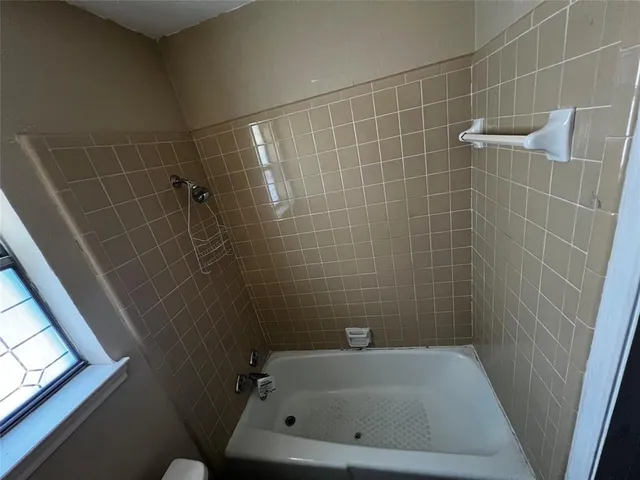 a bathroom with a bathtub and window