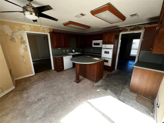 a view of kitchen with refrigerator and window