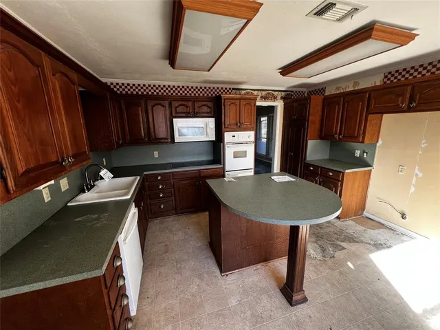 a kitchen with a table chairs and a refrigerator