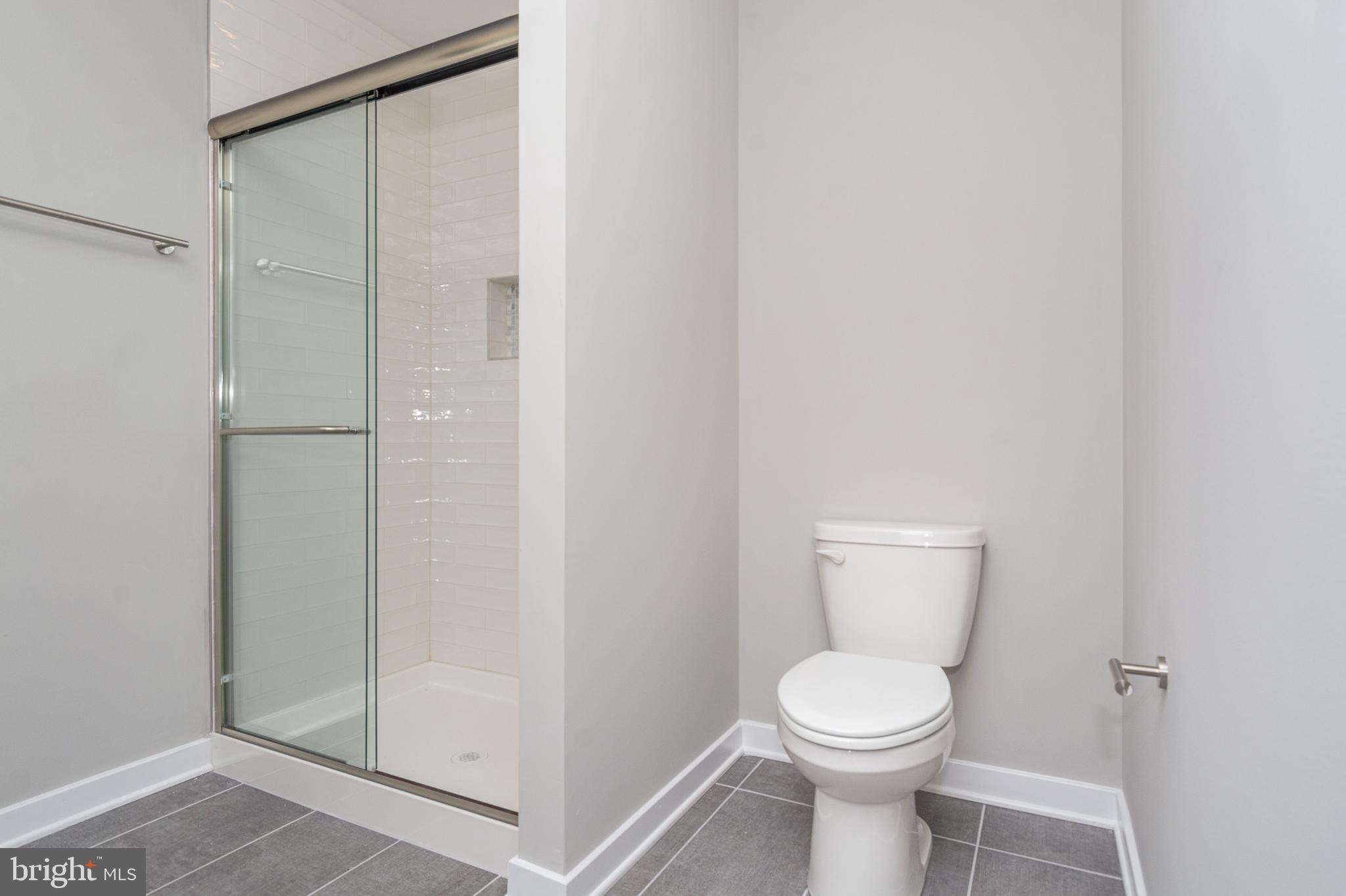 846 Edmondson Avenue Baltimore, MD 21201 - Photo 24 of 43 a white toilet sitting next to a shower