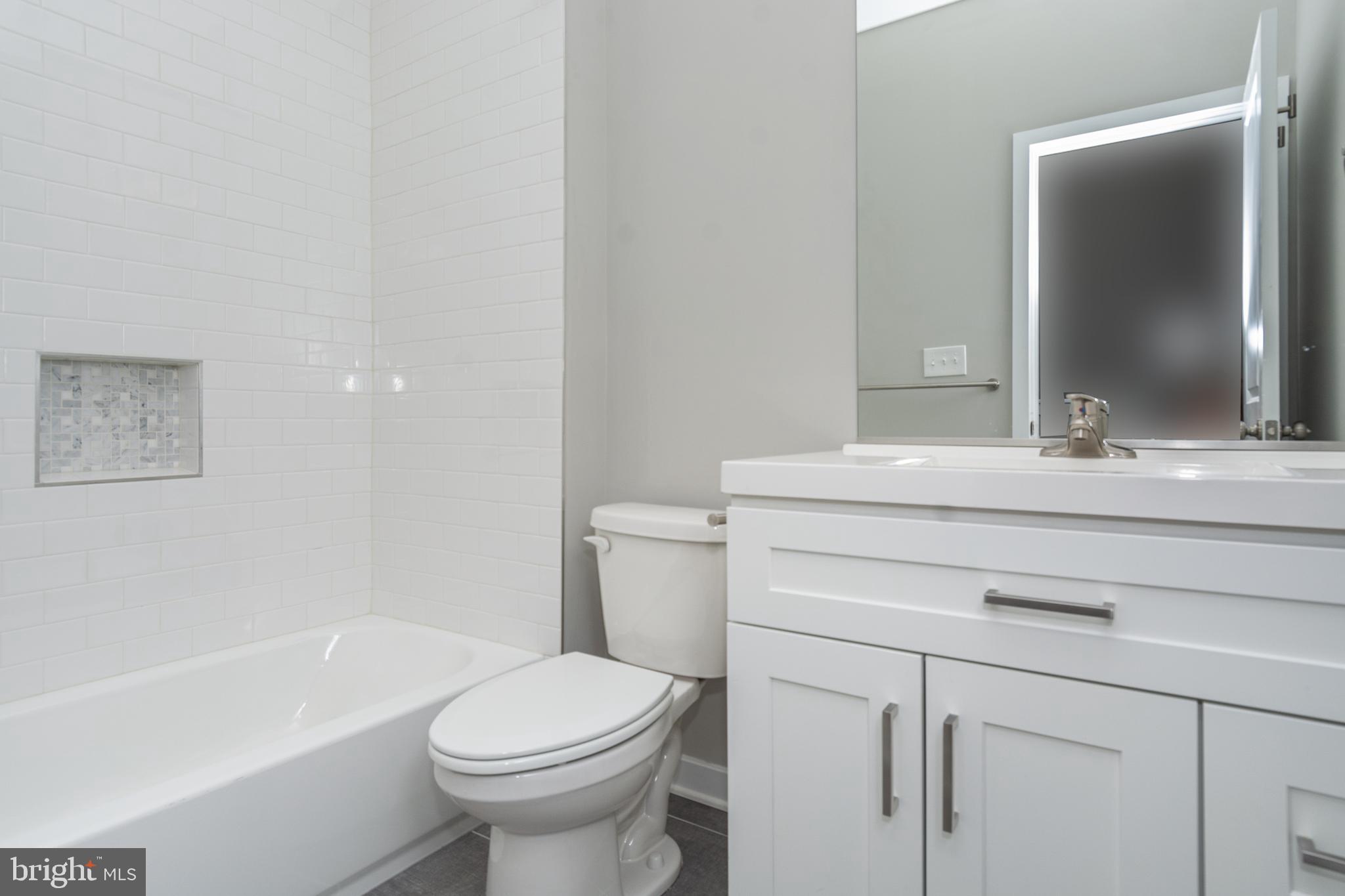 846 Edmondson Avenue Baltimore, MD 21201 - Photo 29 of 43 a bathroom with a sink toilet and a bathtub