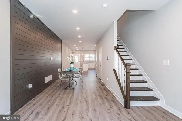 a view of a room with furniture and wooden floor