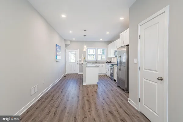 a kitchen with stainless steel appliances granite countertop white cabinets granite counter tops and a stove