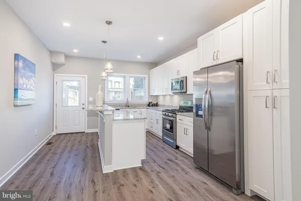 a kitchen with cabinets and a stove