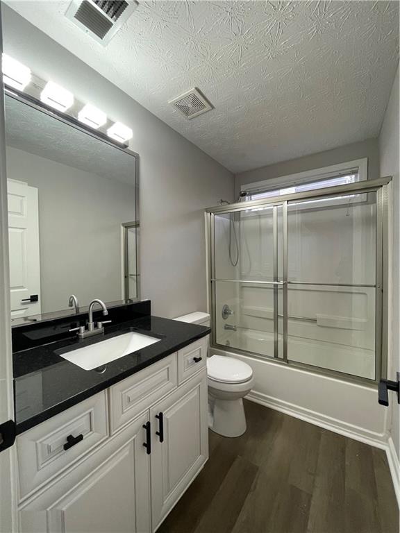 3920 Knotts Pass Road Southwest Snellville, GA 30039 - Photo 12 of 19 a bathroom with a double vanity sink toilet mirror and shower
