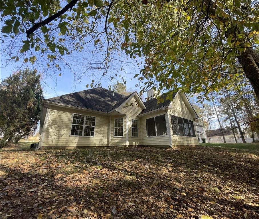 3920 Knotts Pass Road Southwest Snellville, GA 30039 - Photo 14 of 19 a front view of a house with a garden