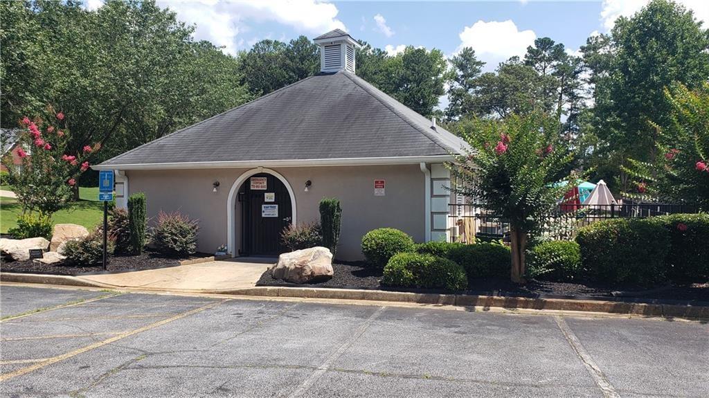 3920 Knotts Pass Road Southwest Snellville, GA 30039 - Photo 19 of 19 a front view of a house with a yard and potted plants