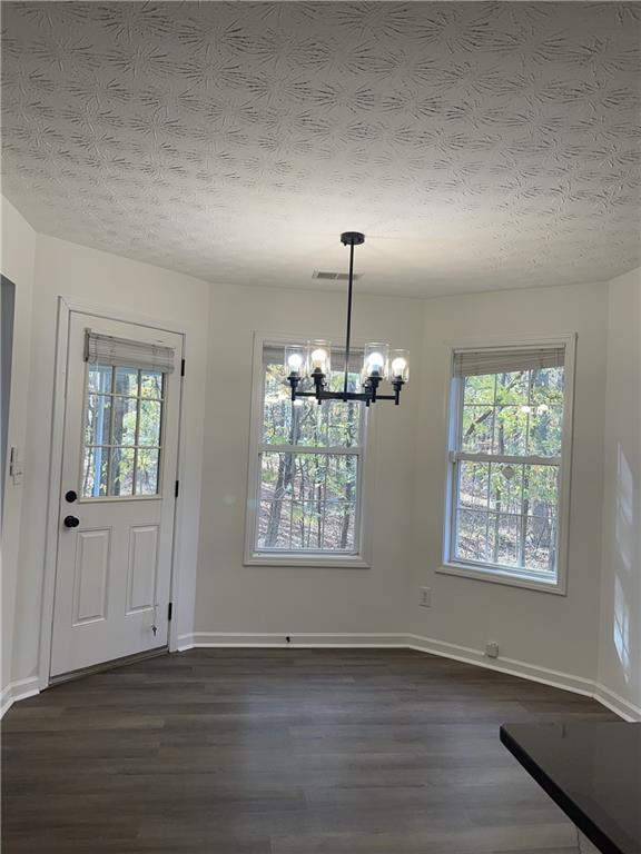 3920 Knotts Pass Road Southwest Snellville, GA 30039 - Photo 8 of 19 an empty room with wooden floor chandelier and windows