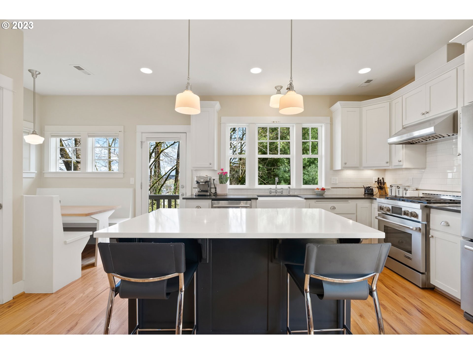 2126 Northwest 32nd Avenue Portland, OR 97210 - Photo 11 of 48 a kitchen with a dining table chairs sink and cabinets