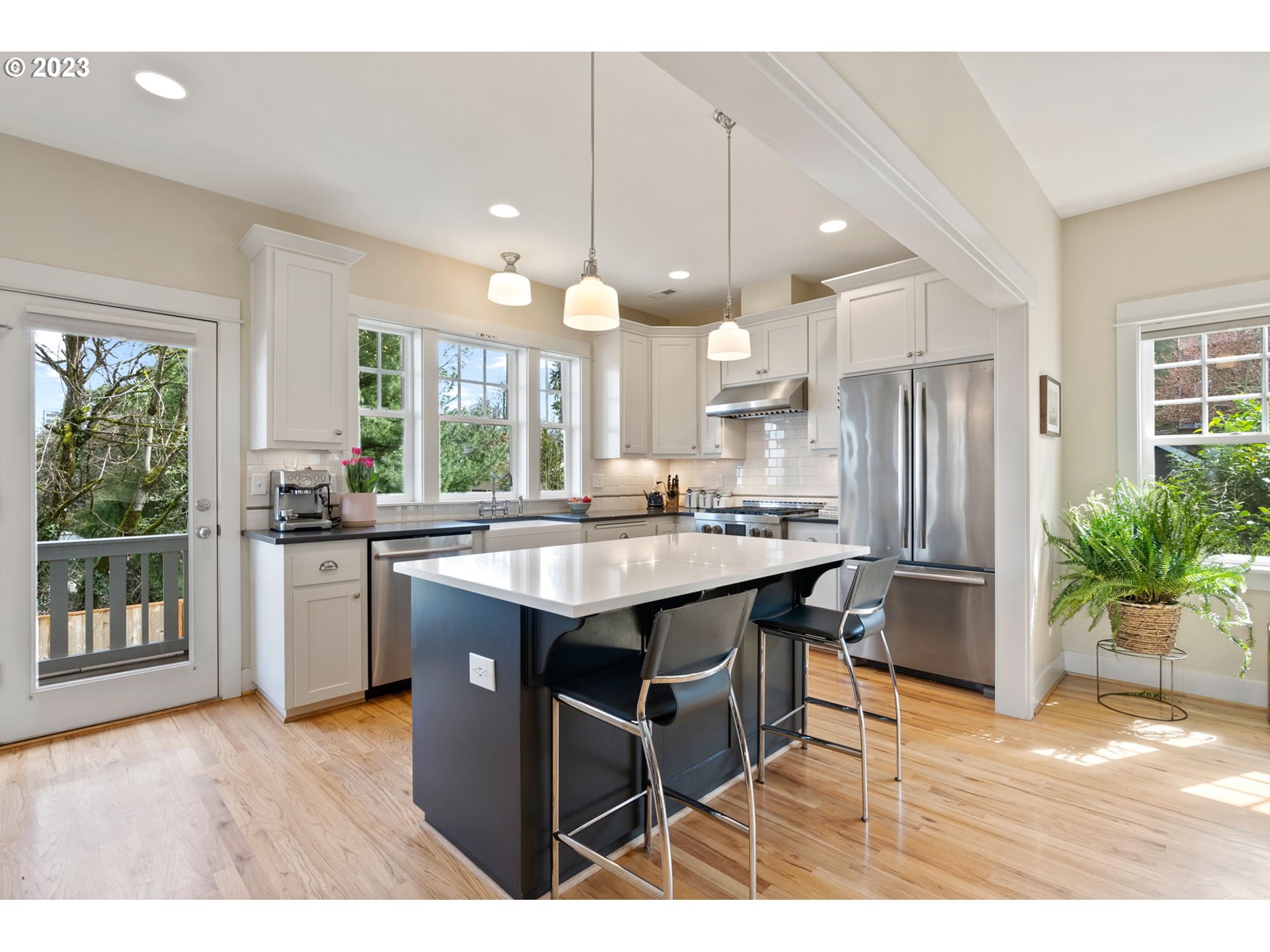 2126 Northwest 32nd Avenue Portland, OR 97210 - Photo 12 of 48 a kitchen with stainless steel appliances granite countertop a sink a stove a refrigerator and a microwave
