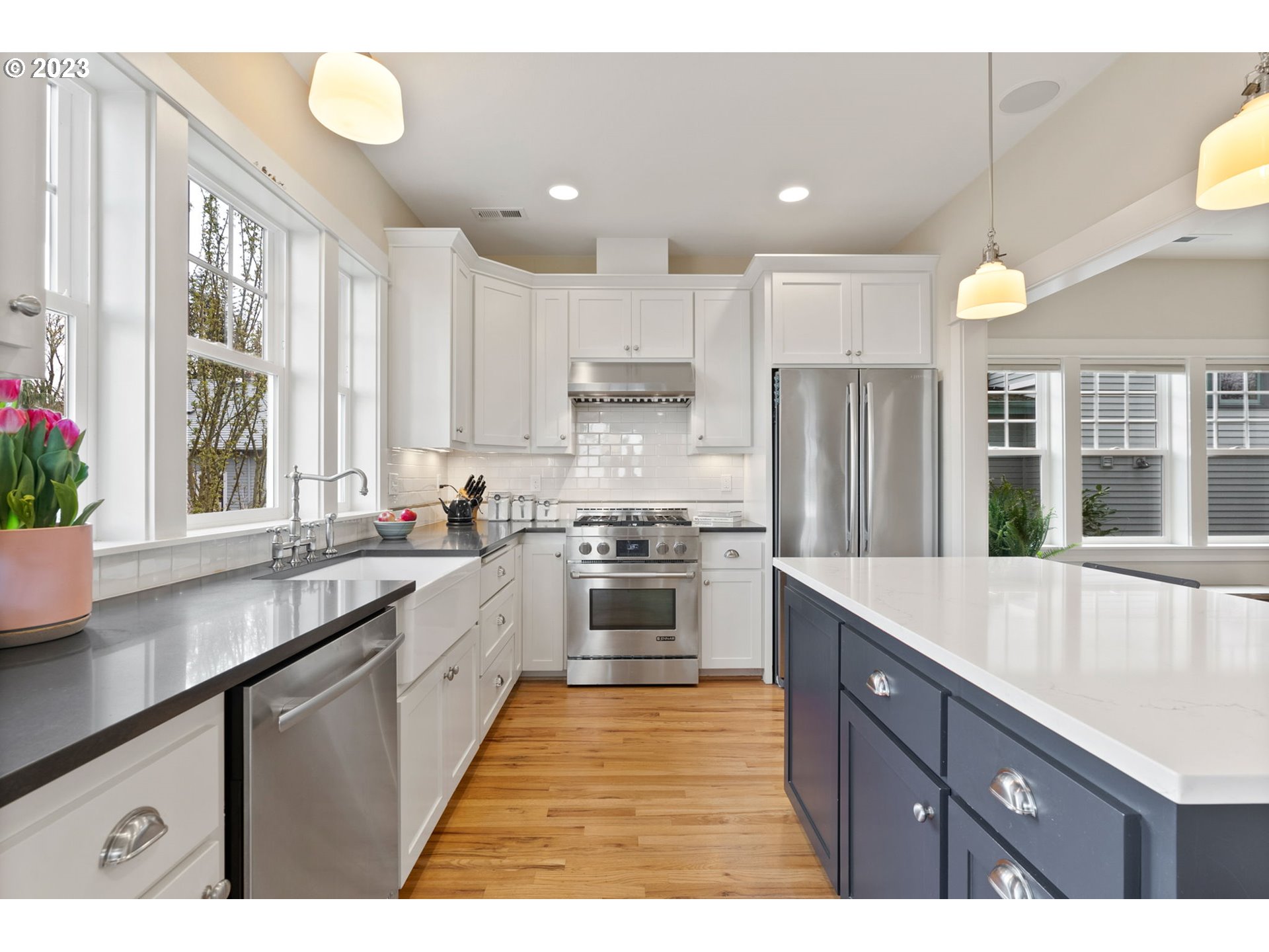 2126 Northwest 32nd Avenue Portland, OR 97210 - Photo 13 of 48 a kitchen with kitchen island granite countertop a sink appliances cabinets and a counter top space