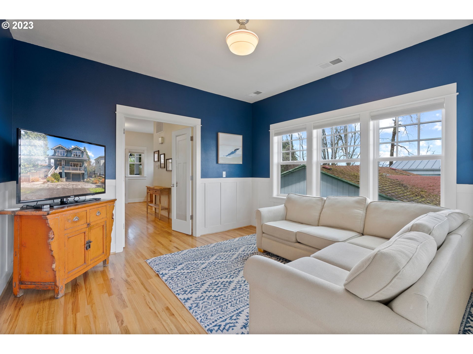 2126 Northwest 32nd Avenue Portland, OR 97210 - Photo 18 of 48 a living room with furniture and a flat screen tv