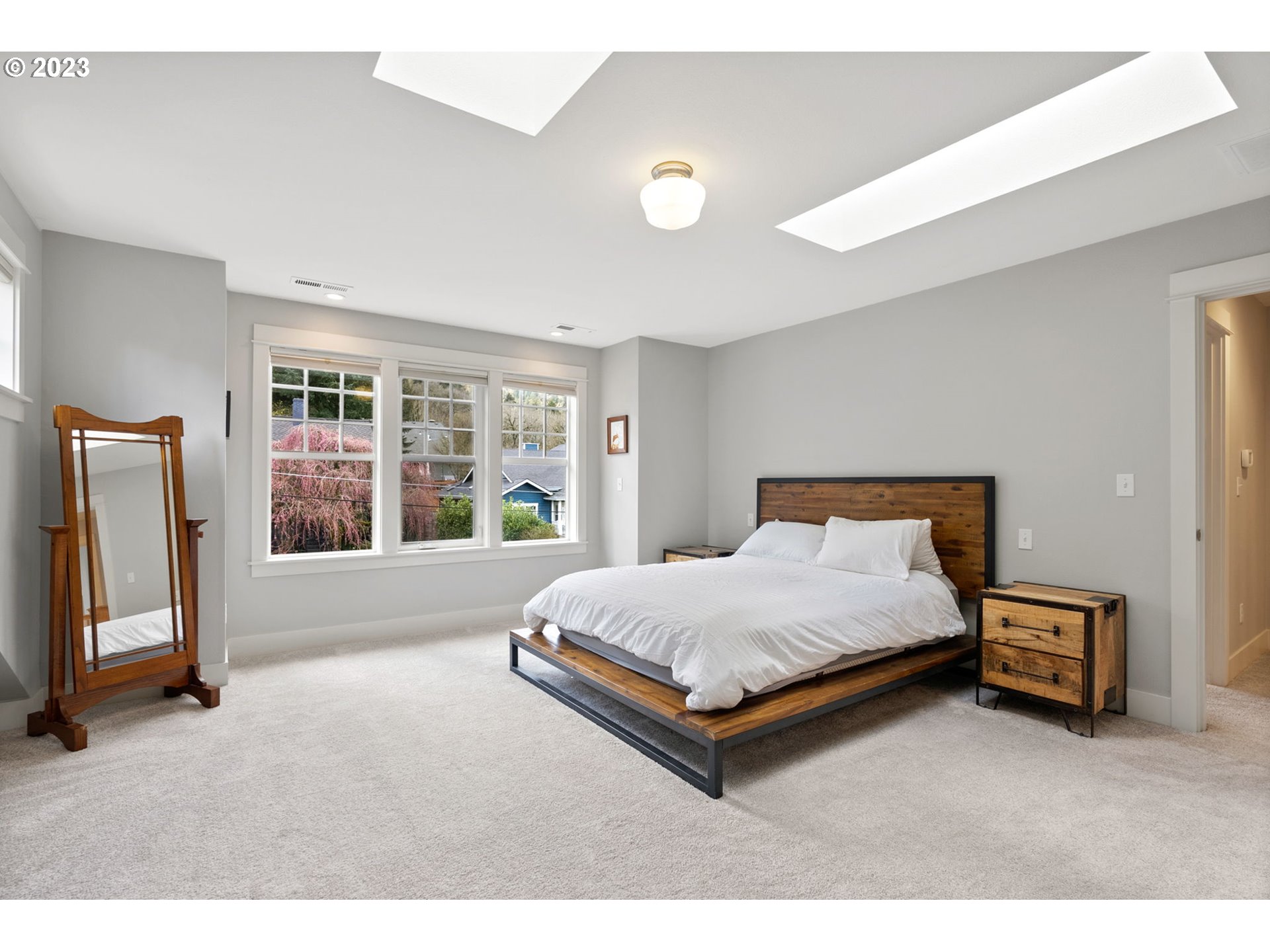 2126 Northwest 32nd Avenue Portland, OR 97210 - Photo 21 of 48 a spacious bedroom with a bed and large windows
