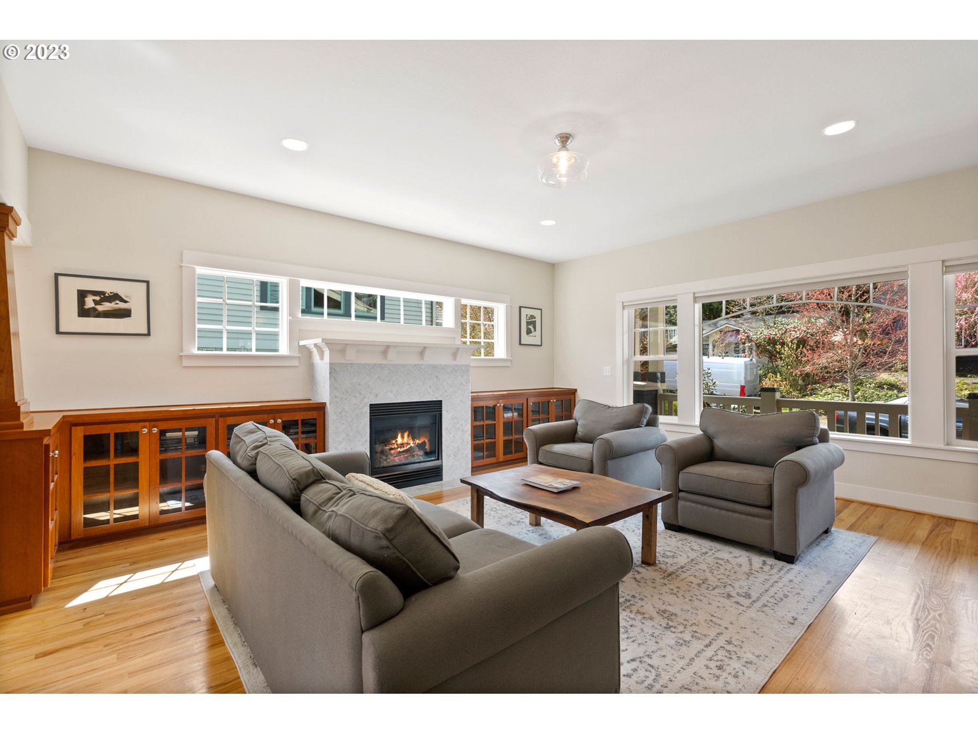 2126 Northwest 32nd Avenue Portland, OR 97210 - Photo 5 of 48 a living room with furniture a fireplace and a large window