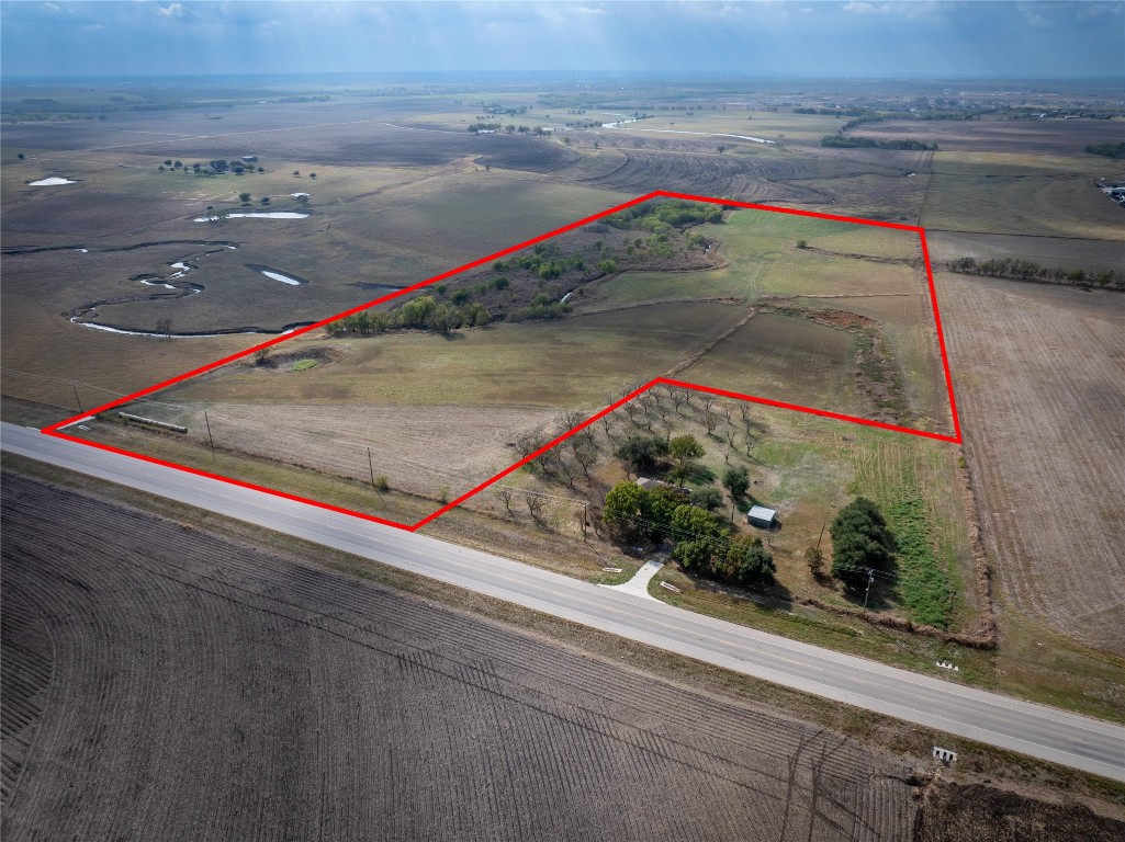 Aerial view of sparsely populated area featuring property parcel outlined