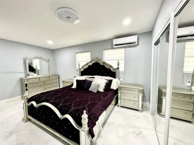 a bed room with a bed window and dresser