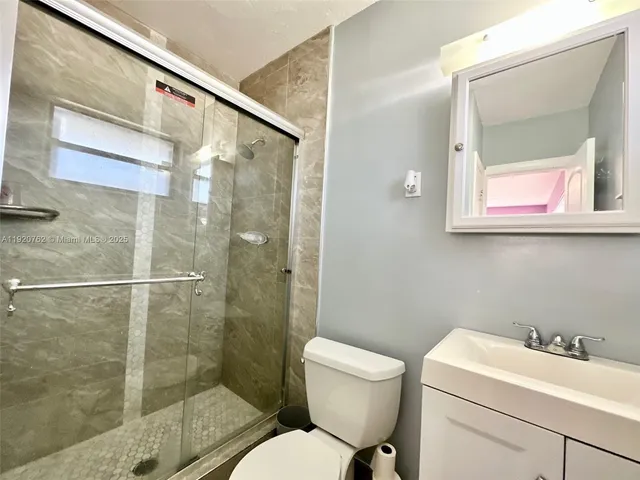 a bathroom with a toilet sink and shower