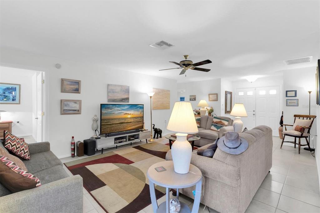 9052 Arundle Place New Port Richey, FL 34655 - Photo 5 of 57 a living room with furniture potted plant and a flat screen tv