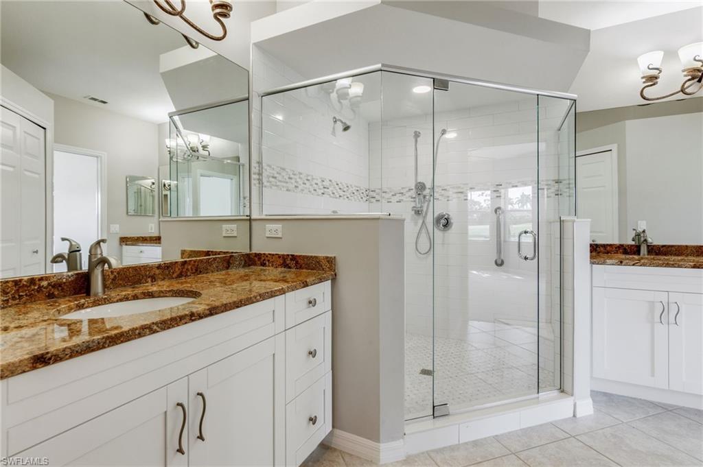 20031 Seagrove Street, Unit 1403 Estero, FL 33928 - Photo 13 of 28 a bathroom with a granite countertop sink mirror and shower