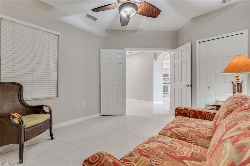 20031 Seagrove Street, Unit 1403 Estero, FL 33928 - Photo 18 of 28 a spacious bedroom with a bed and ceiling fan